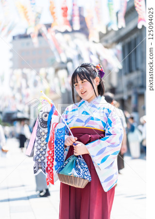 A girl wearing a hakama on Kawagoe Taisho Roman Street 125094025