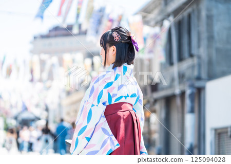 A girl wearing a hakama on Kawagoe Taisho Roman Street 125094028