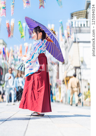 A girl wearing a hakama on Kawagoe Taisho Roman Street 125094034