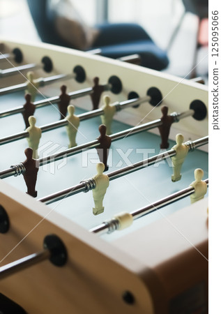 Close-up of foosball table players in brown and cream, indoor light and focus. High quality photo 125095066