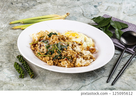 Rice with minced meat and basil 125095612