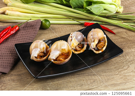 Snails baked with garlic and spices Snails baked with garlic and spices 125095661