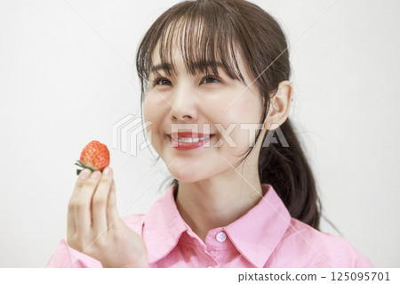 Woman eating strawberries 125095701