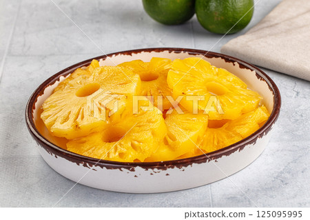 Sweet canned pineapple slices in syrope 125095995