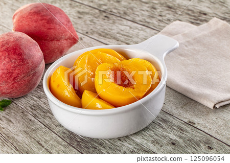 Sweet ripe yellow canned peaches Sweet ripe yellow canned peaches 125096054