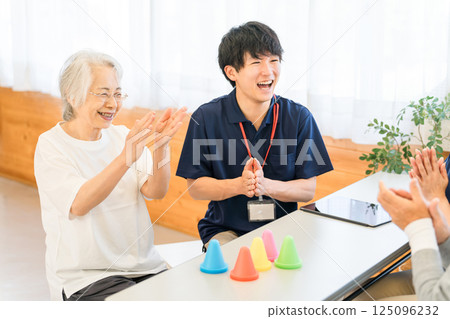 Young Asian male staff and senior woman working in rehabilitation facility, nursing home 125096232