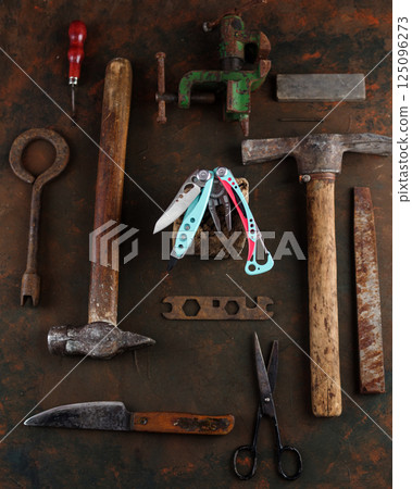 Beautiful new knife and old tools. Old rusty tools around the new knife. Vintage and new. Vertical frame. 125096273