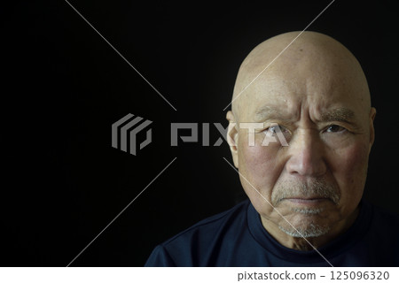 Close-up of an elderly man's troubled face 125096320