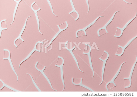 Dental floss with handle on pink background, flat lay 125096591
