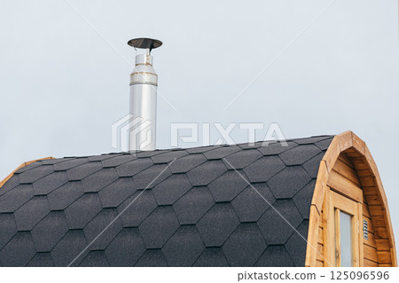 Stainless Steel Chimney Pipe on Arched Asphalt Roof Stainless Steel Chimney Pipe on Arched Asphalt Roof 125096596