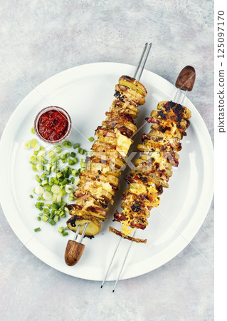 Delicious skewers with potatoes. 125097170