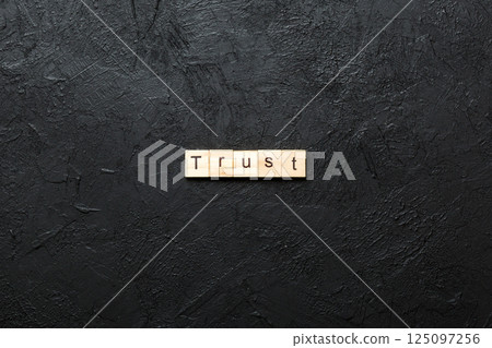 TRUST word written on wood block. TRUST text on table, concept 125097256