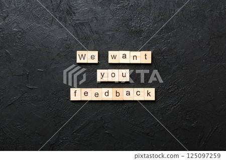 We want your feedback word written on wood block. We want your feedback text on cement table for your desing, Top view concept We want your feedback word written on wood block. We want your feedback text on cement table for your desing, Top view concept 125097259