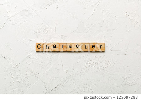 CHARACTER word written on wood block. CHARACTER text on cement table for your desing, concept 125097288