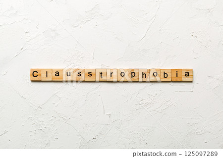 claustrophobia word written on wood block. claustrophobia text on table, concept 125097289