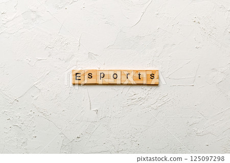 Esports word written on wood block. Esports text on cement table for your desing, Top view concept Esports word written on wood block. Esports text on cement table for your desing, Top view concept 125097298