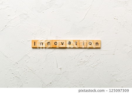 INNOVATION word written on wood block. INNOVATION text on table, concept INNOVATION word written on wood block. INNOVATION text on table, concept 125097309