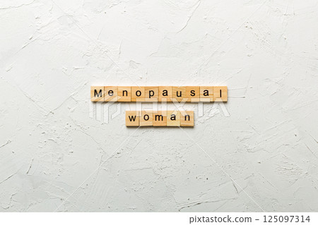 menopausal woman word written on wood block. menopausal woman text on cement table for your desing, concept 125097314