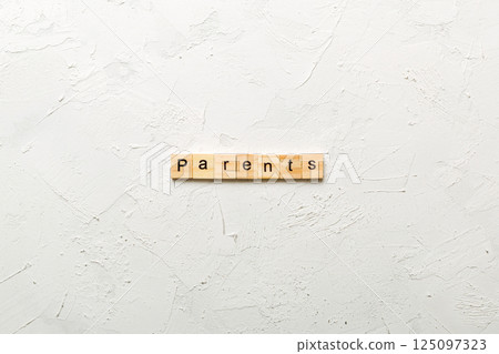 Parents word written on wood block. Parents text on cement table for your desing, concept 125097323