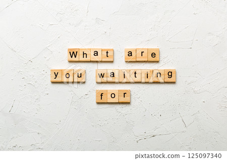 What are you waiting for word written on wood block. What are you waiting for text on cement table for your desing, Top view concept 125097340