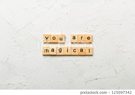 You are magical word written on wood block. You are magical text on cement table for your desing, concept 125097342