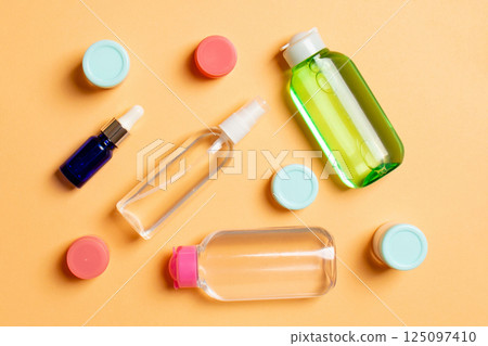 Cosmetics SPA branding mock-up, top view with copy space. set of tubes and jars of cream flat lay on colored background 125097410