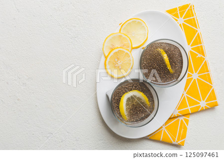Healthy breakfast or morning with chia seeds and lemon on table background, vegetarian food, diet and health concept. Chia pudding with lemon 125097461