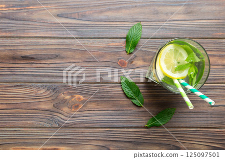 Caipirinha, Mojito cocktail, vodka or soda drink with lime, mint and straw on table background. Refreshing beverage with mint and lime in glass top view flat lay Caipirinha, Mojito cocktail, vodka or soda drink with lime, mint and straw on table background. Refreshing beverage with mint and lime in glass top view flat lay 125097501