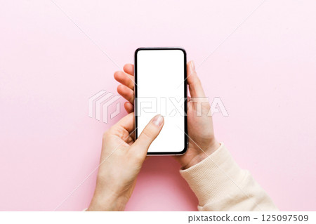 Top view of woman hands holding smart phone with blank copy space screen for your text message or information content. woman hand using phone white screen on top view 125097509