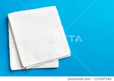 Top view of white towels with copy space on colored background 125097568