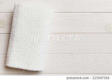 Top view of white towels with copy space on colored background Top view of white towels with copy space on colored background 125097569