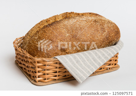 Freshly baked bread on basket against natural background. Perspective view bread copy space 125097571