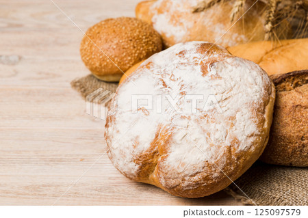 Homemade natural breads. Different kinds of fresh bread as background, perspective view with copy space 125097579