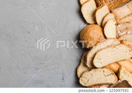 Homemade natural breads. Different kinds of fresh bread as background, top view with copy space Homemade natural breads. Different kinds of fresh bread as background, top view with copy space 125097591