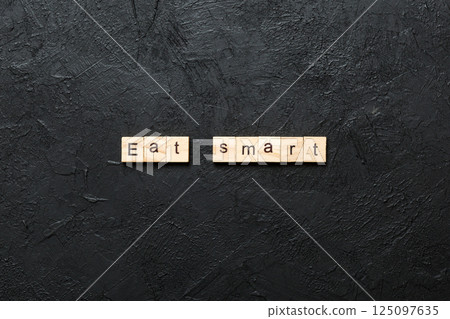 Eat smart word written on wood block. Eat smart text on cement table for your desing, Top view concept 125097635