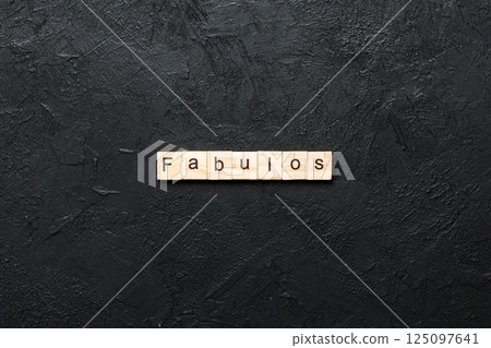 Fabulous word written on wood block. Fabulous text on cement table for your desing, concept 125097641