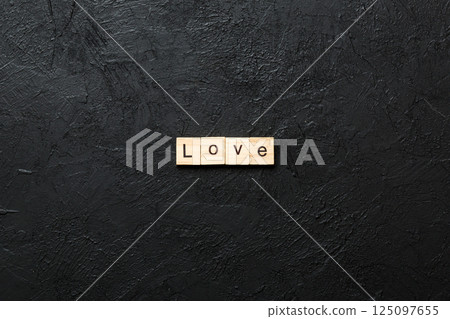 love word written on wood block. love text on table, concept love word written on wood block. love text on table, concept 125097655