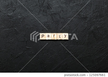 PARTY word written on wood block. PARTY text on cement table for your desing, concept 125097661