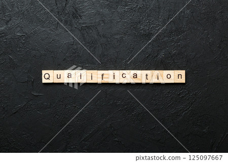 qualification word written on wood block. qualification text on table, concept qualification word written on wood block. qualification text on table, concept 125097667