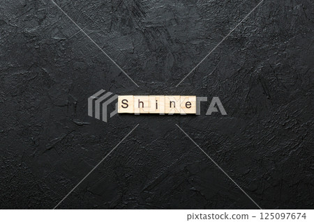 Shine word written on wood block. Shine text on cement table for your desing, concept Shine word written on wood block. Shine text on cement table for your desing, concept 125097674