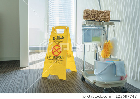 A sign showing work in progress and cleaning tools in front of the women's restroom in an office building. Photo courtesy of Tokyo Electronics College, Denpa Gakuen School Corporation. 125097748