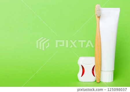 toothpaste and toothbrush top view with copy space on colored background. Flat lay. Dental hygiene. Oral care products on light background. Body care concept 125098037