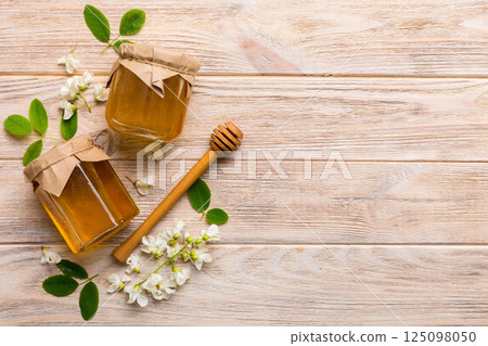 honey jar with acacia flowers and leaves. fresh honey top view flat lay 125098050