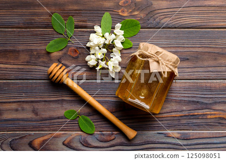 honey jar with acacia flowers and leaves. fresh honey top view flat lay 125098051
