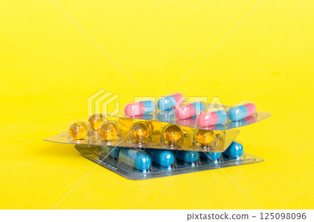 too many different pill cartridges stacked. selective Focus. Packs of blister pills with tablets. Colored pastilles packages. A pile of medicine in blister packs. Pharmaceutical blister packs 125098096