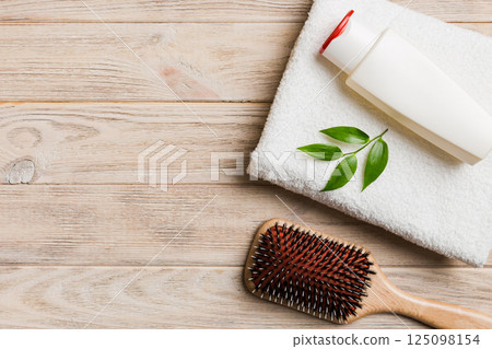 cosmetic for hair care, cream and towel on a colored background top view. flat lay 125098154