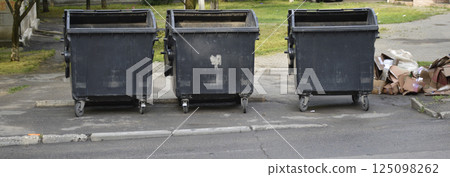 household garbage scattered near the trash garbage can 125098262