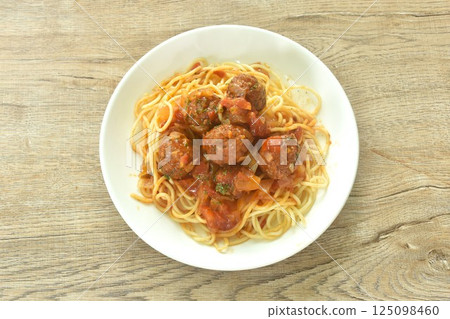 spaghetti dressing fried meatball stuffed cheese in chop onion and tomato ketchup sauce on plate spaghetti dressing fried meatball stuffed cheese in chop onion and tomato ketchup sauce on plate 125098460