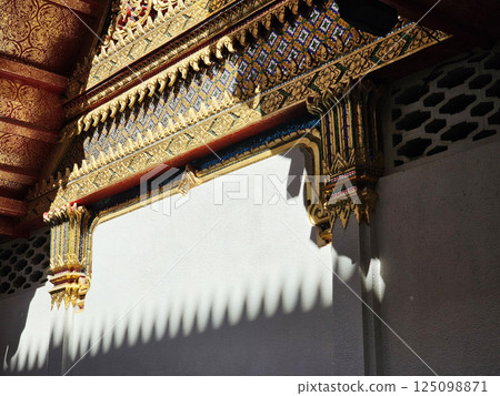Vintage Golden Thai Traditional Sculpture in front of Buddhist Church. Vintage Golden Thai Traditional Sculpture in front of Buddhist Church. 125098871
