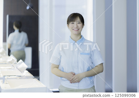 Portrait of a young female office building cleaner. Photo courtesy of Tokyo Electronics College, Denpa Gakuen Corporation. 125099306